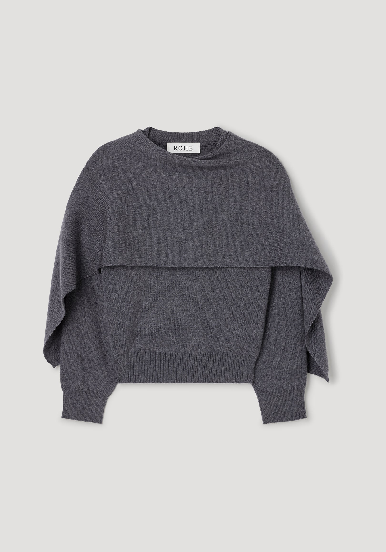 Dark grey melange knitted cape jumper with long sleeves, ribbed cuffs and hem, featuring a layered cape design for a stylish and cozy look. Cape jumper | dark grey melange