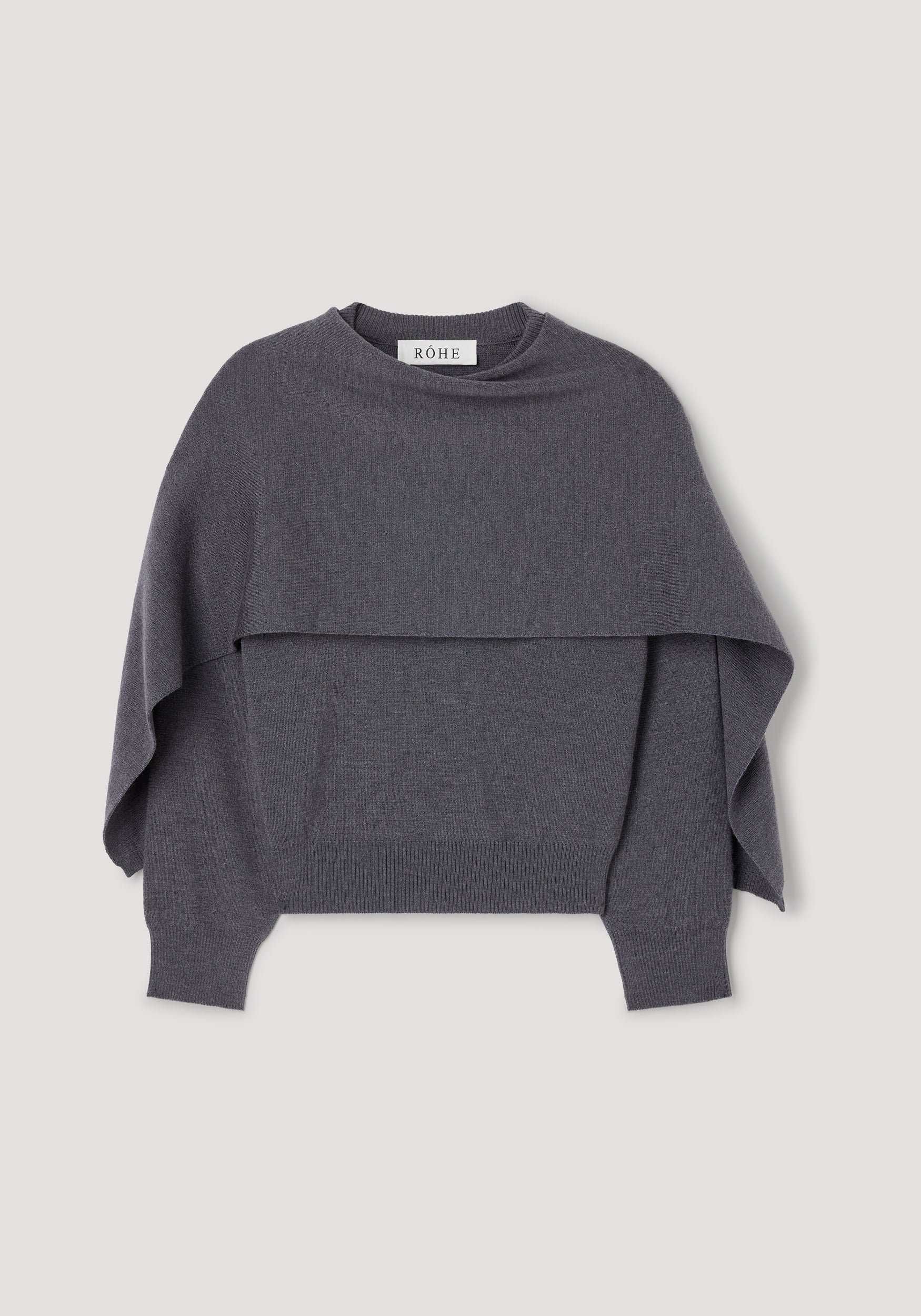 Dark grey melange knitted cape jumper with long sleeves, ribbed cuffs and hem, featuring a layered cape design for a stylish and cozy look. Cape jumper | dark grey melange