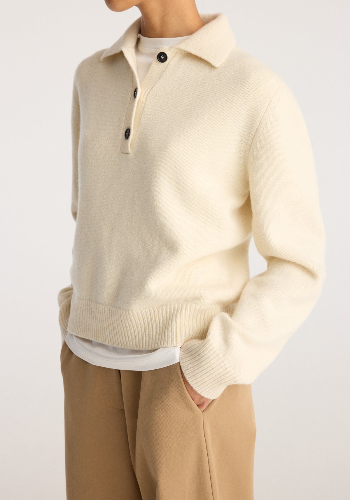 Wool-cashmere polo | cream shown on a model with a collared neckline button placket long sleeves and ribbed hem styled with tan trousers