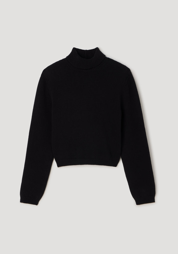 Black knitted Statement shoulder turtleneck | black with long sleeves and a fitted hem, laid flat on a light gray background.
