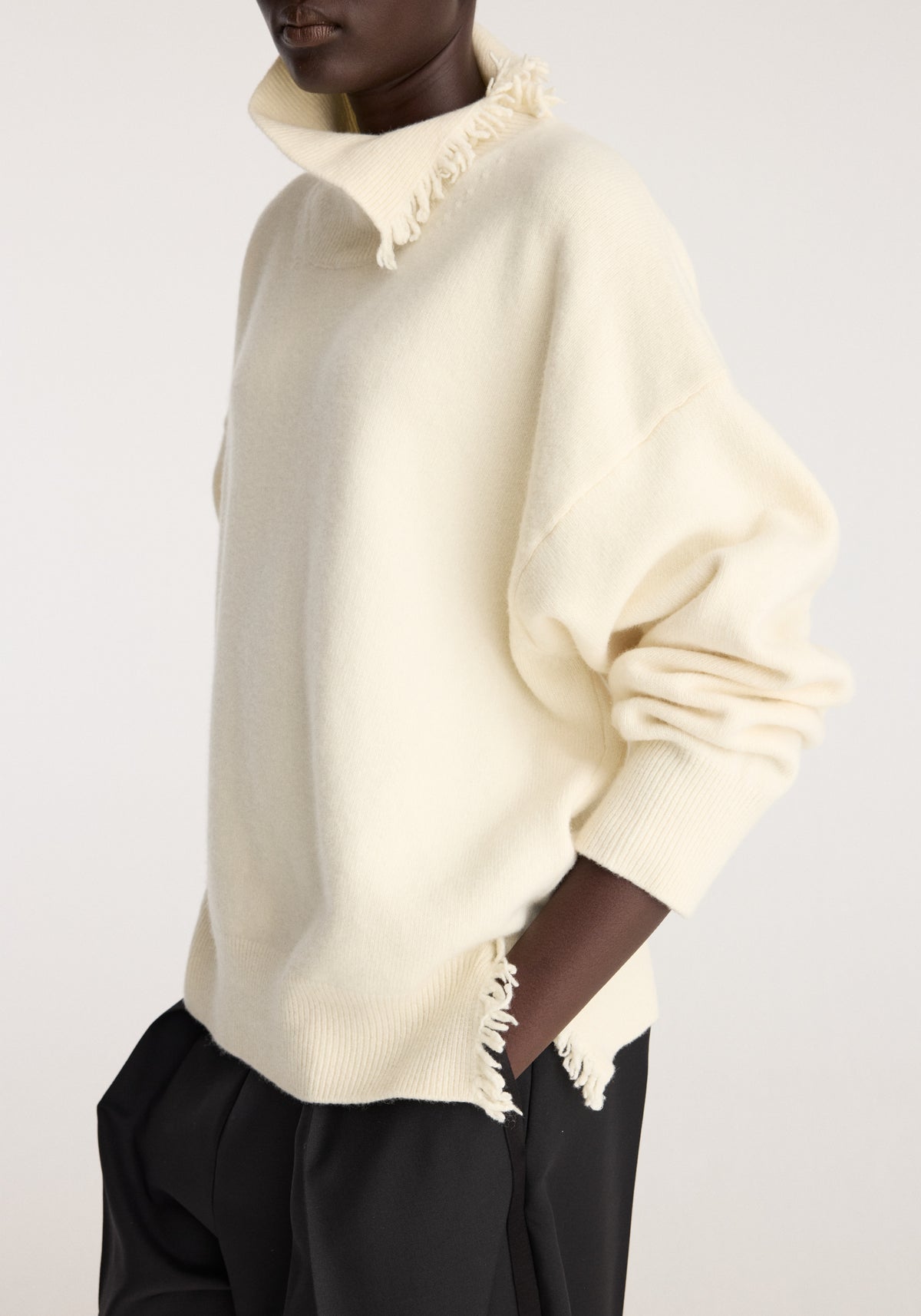 Turtleneck with raw details | off white, relaxed sweater with fringed raw edges, rolled collar and voluminous sleeves styled with black trousers