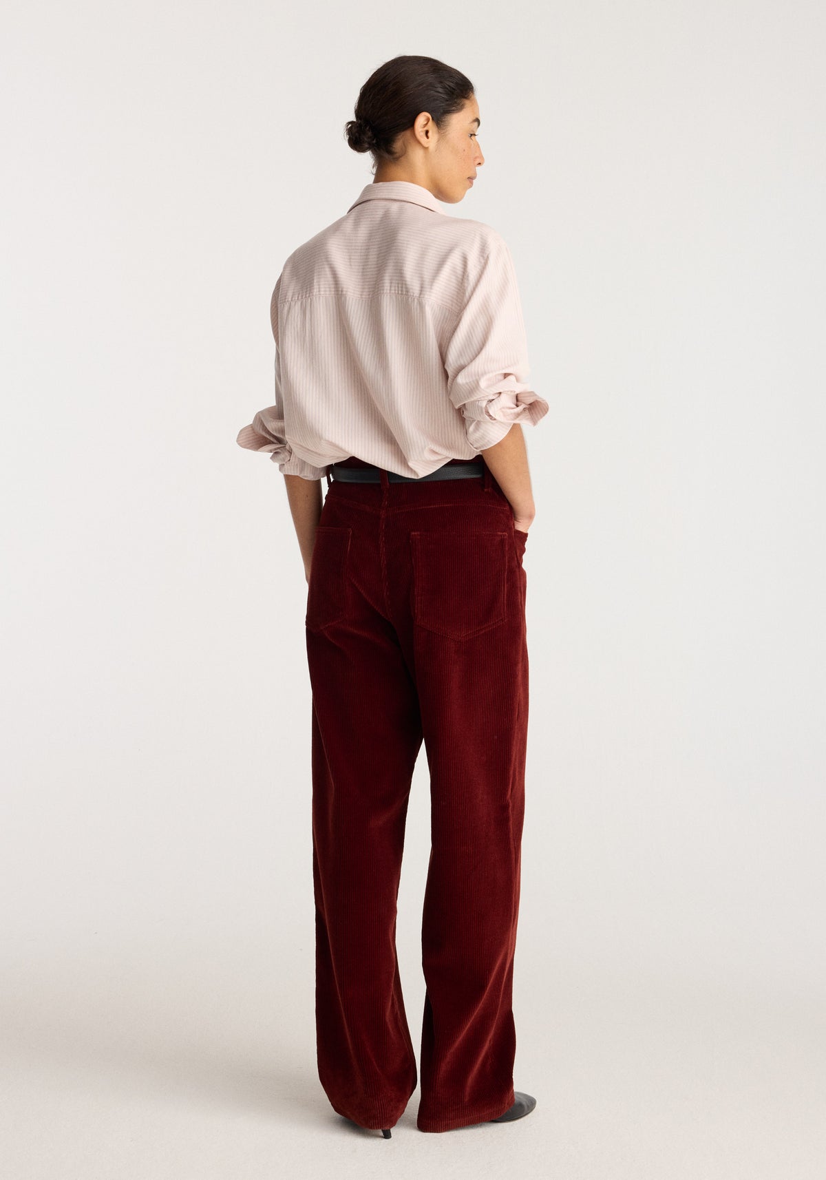 Bruun - Signature baggy corduroy trousers | wine shown from the back on a model with a relaxed fit and wide legs in deep red corduroy fabric