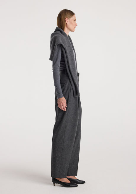 Woman wearing Daria - Single pleat straight leg trousers | grey slub paired with a fitted long-sleeve top and a sweater draped over her shoulders, styled with black flats.