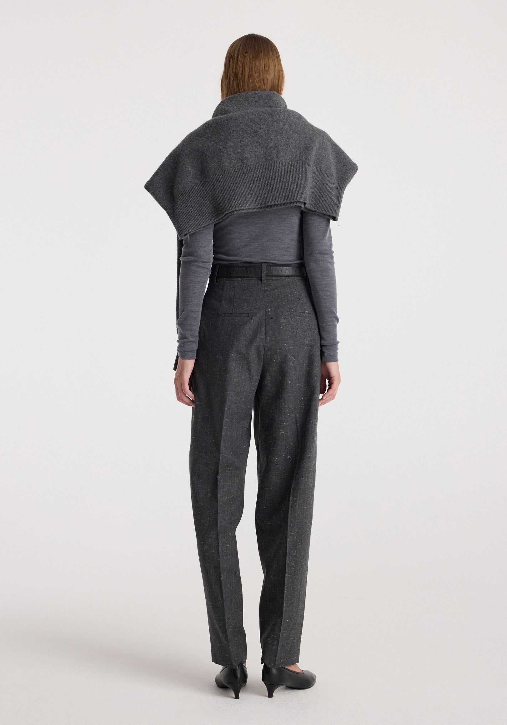 Woman seen from behind wearing Daria - Single pleat straight leg trousers | grey slub paired with a long-sleeve top and a draped shawl over the shoulders.
