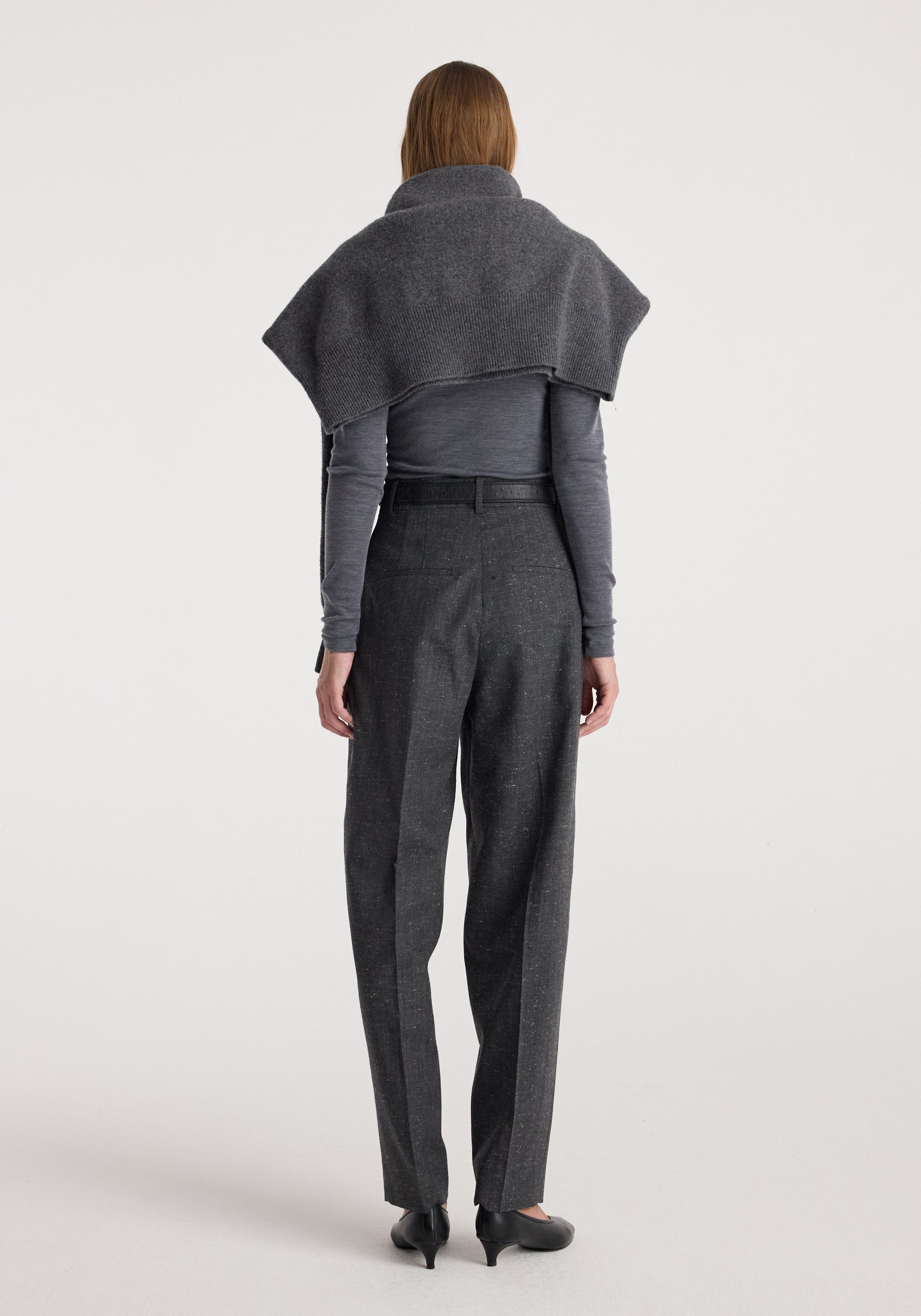 Woman seen from behind wearing Daria - Single pleat straight leg trousers | grey slub paired with a long-sleeve top and a draped shawl over the shoulders.