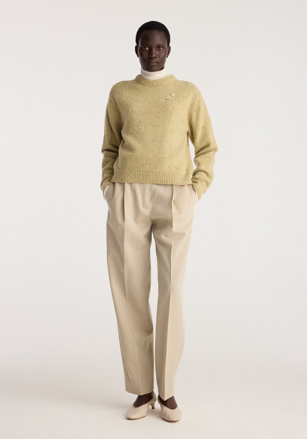 Daria - Single pleat straight leg trousers | butter shown on a model with front pleats and a relaxed straight leg fit paired with a neutral knit sweater