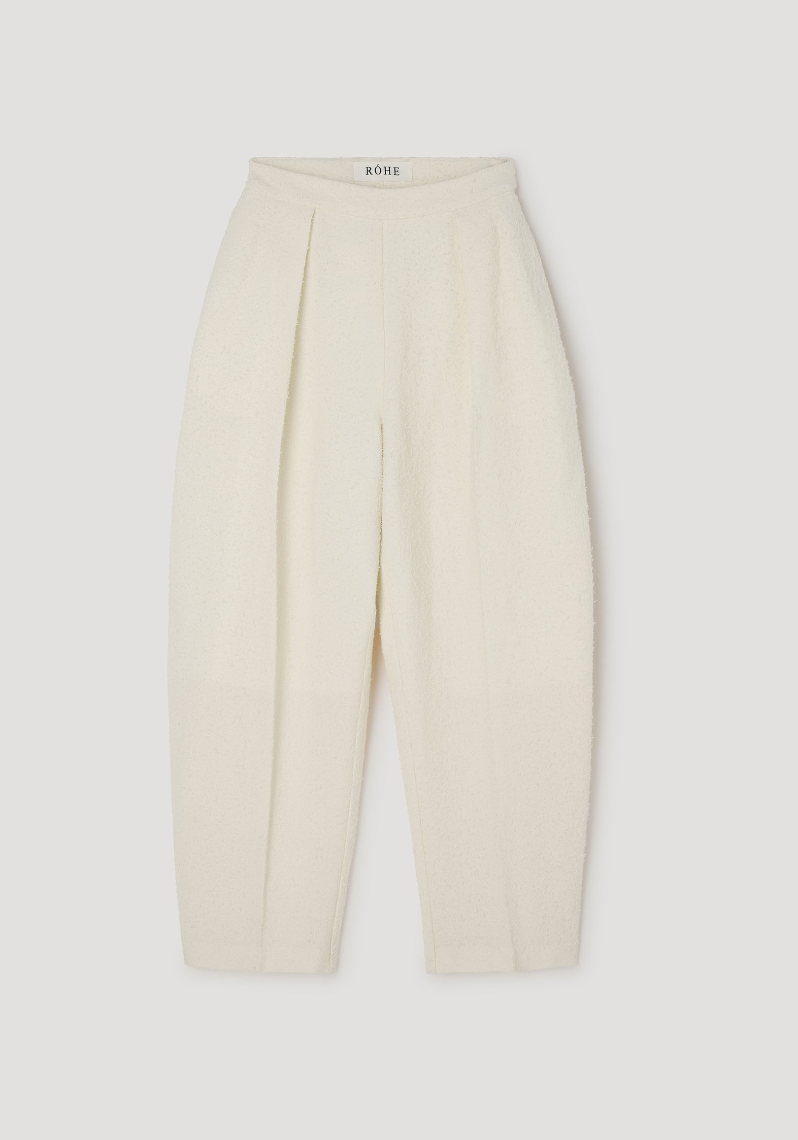 Puck - Sculptural bouclé tailored trousers | cream shown flat, featuring a high waist, pleated front, and textured soft bouclé fabric for an elegant silhouette.
