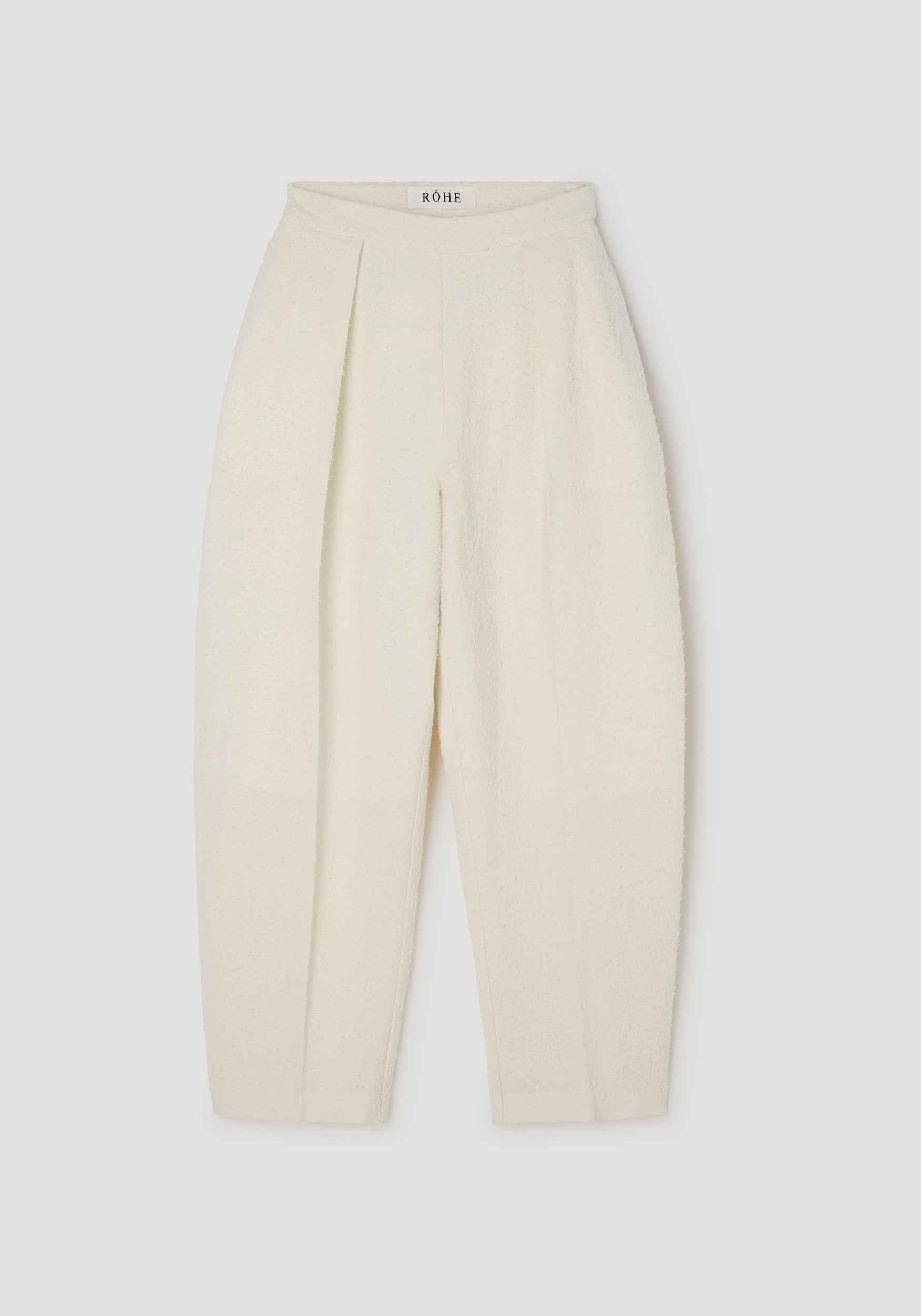 Puck - Sculptural bouclé tailored trousers | cream shown flat, featuring a high waist, pleated front, and textured soft bouclé fabric for an elegant silhouette.