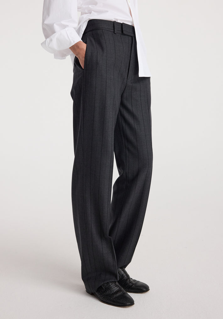 Close-up side view of a person wearing Kee - Straight leg tailored trousers | charcoal stripe paired with black woven shoes and a white shirt.