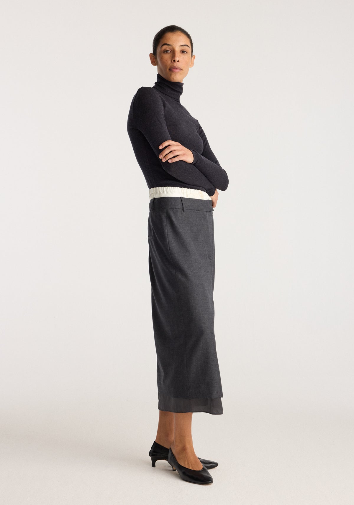 Boxer detailed skirt | dark grey melange shown on a model with a straight midi length, subtle waistband detail and relaxed tailored fit