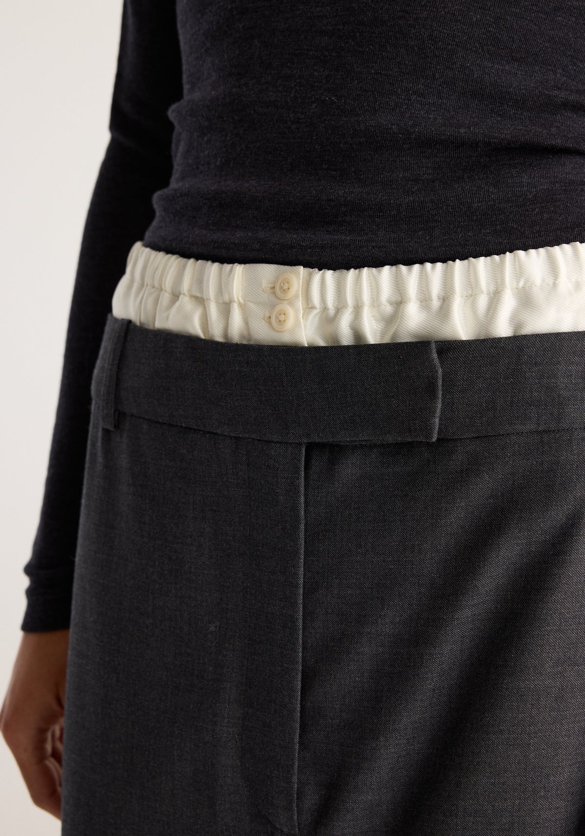 Boxer detailed skirt | dark grey melange shown close up with a cream elastic waistband and button details above a front pocket