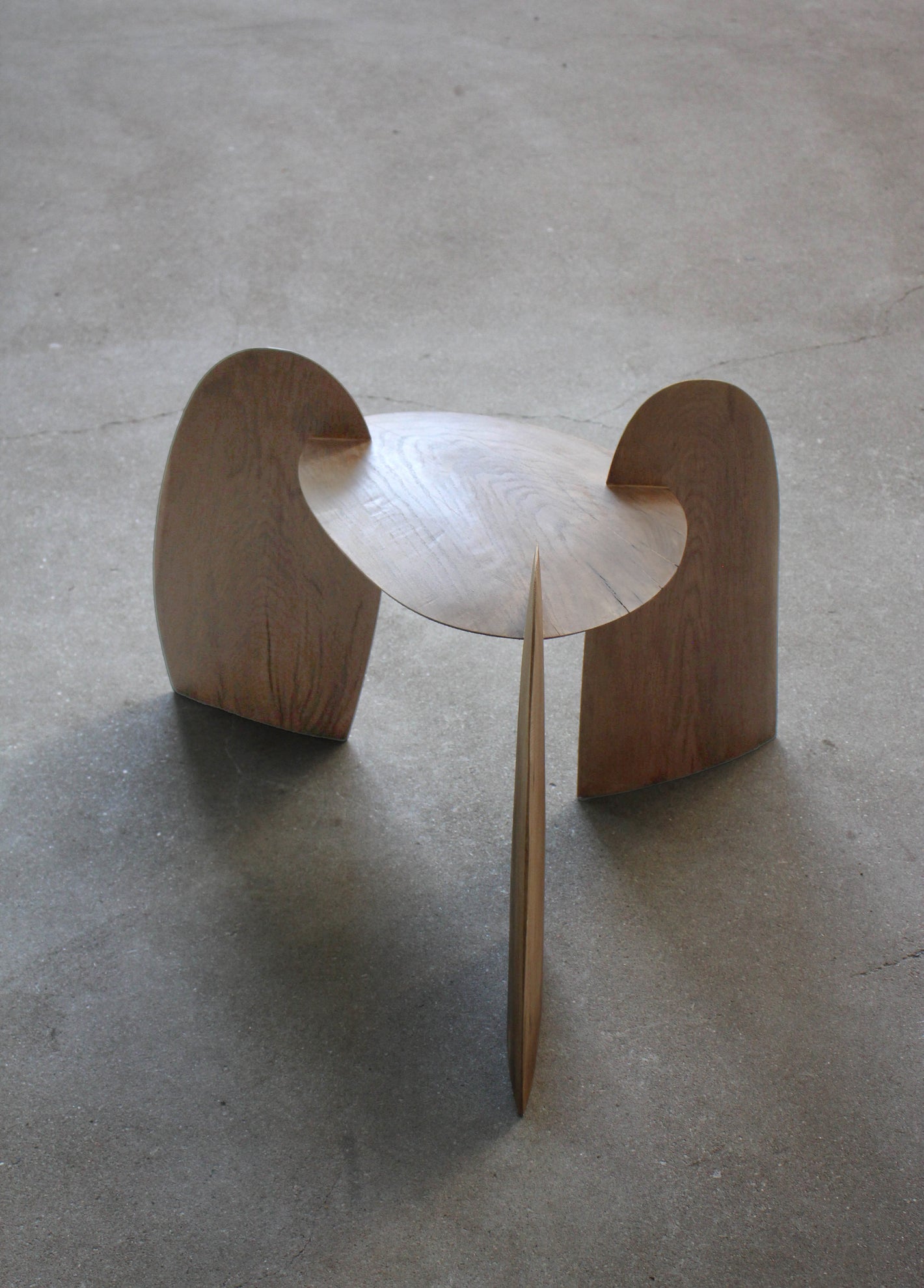 Sculpted Stool | 4673: A three-legged stool with interlocking curved plywood panels, crafted from sustainably harvested oak by Dutch artist Arne Kristian.