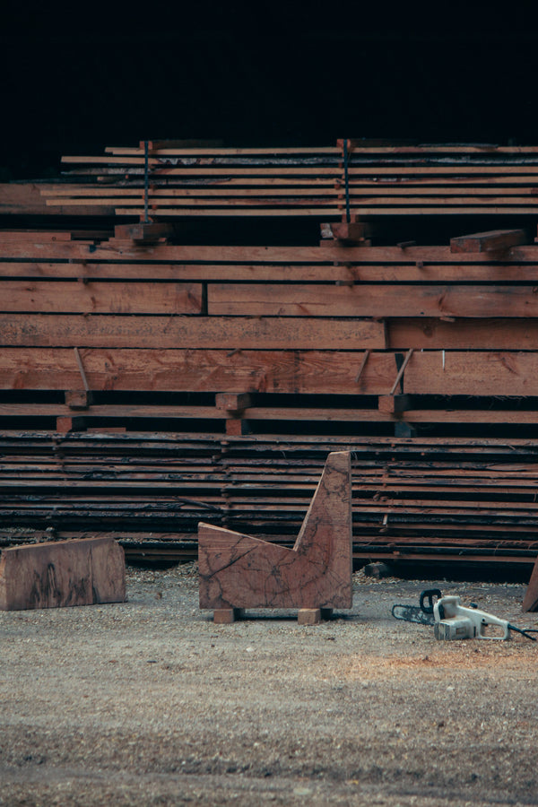 Brutalist Chair | 5788: Inside a sawmill, rough oak blocks and a chainsaw hint at the handcrafted process of this unique, sculptural chair by Arne Kristian.