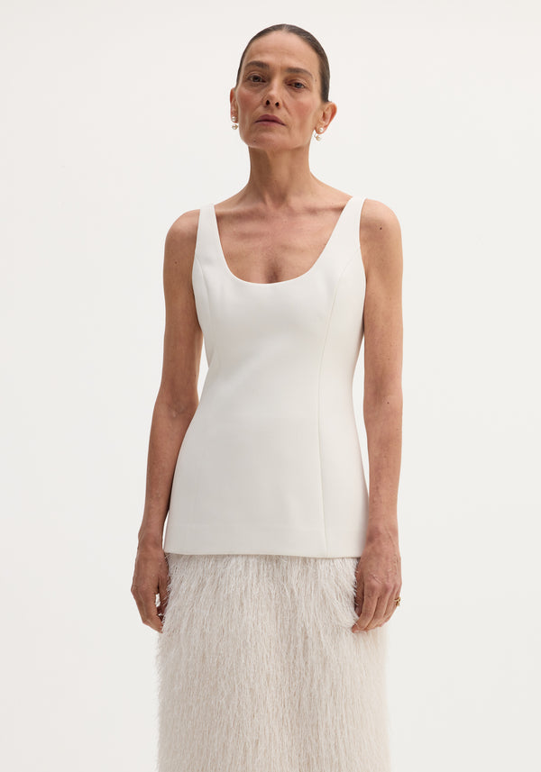Fringe dress | ivory: A tall woman models a sleeveless, scoop-neck bodice with a long, feather-textured skirt, featuring a back slit for ease of movement.