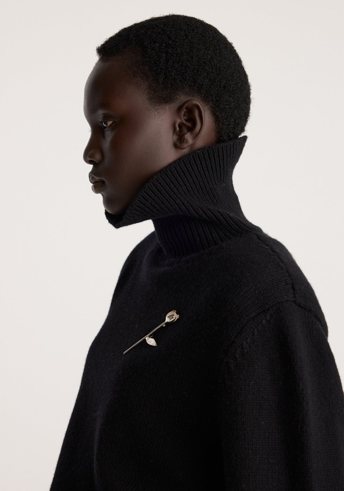 Tulip silver brooch | silver worn on a black high neck sweater in side profile