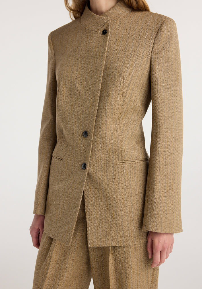 Close-up of a person wearing an Overlap lapel blazer | heritage stripe in muted brown with subtle vertical stripes, featuring a high collar and black buttons.