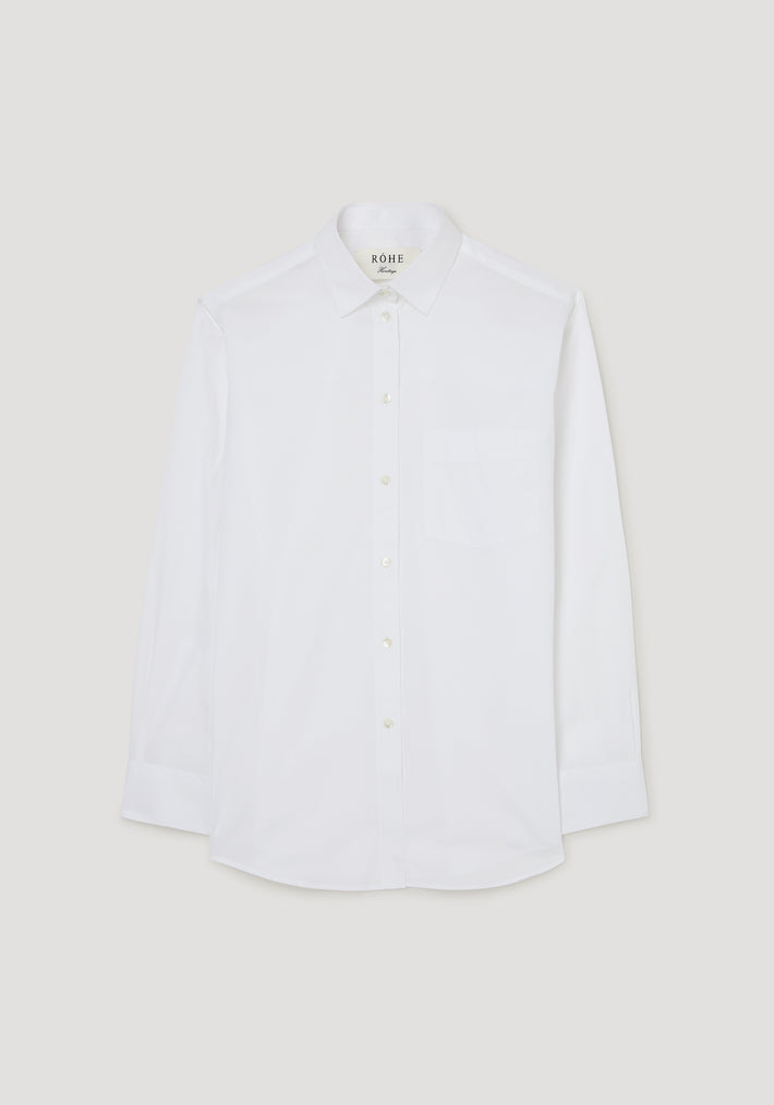 Classic fit shirt | optic white laid flat on a light background, featuring long sleeves, a front pocket, and a button-down collar.