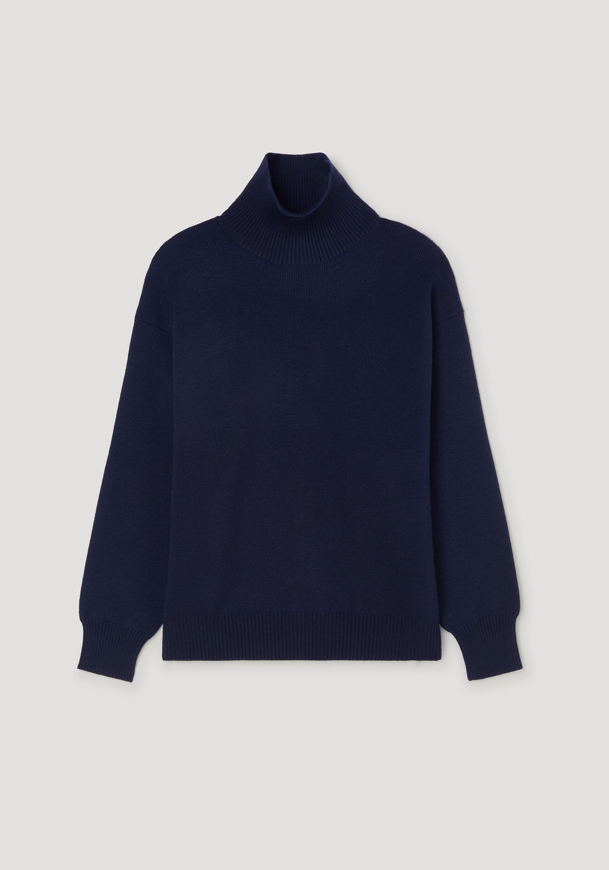 Sculptural compact turtleneck | navy, minimalist navy blue turtleneck sweater with a snug fit and ribbed cuffs and hem, displayed on a neutral background.