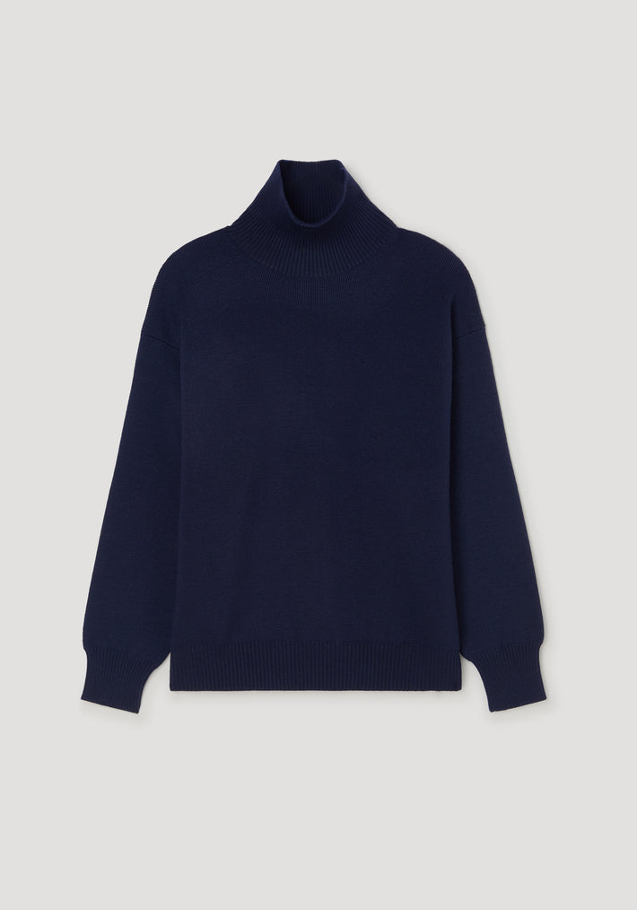 Sculptural compact turtleneck | navy, minimalist navy blue turtleneck sweater with a snug fit and ribbed cuffs and hem, displayed on a neutral background.