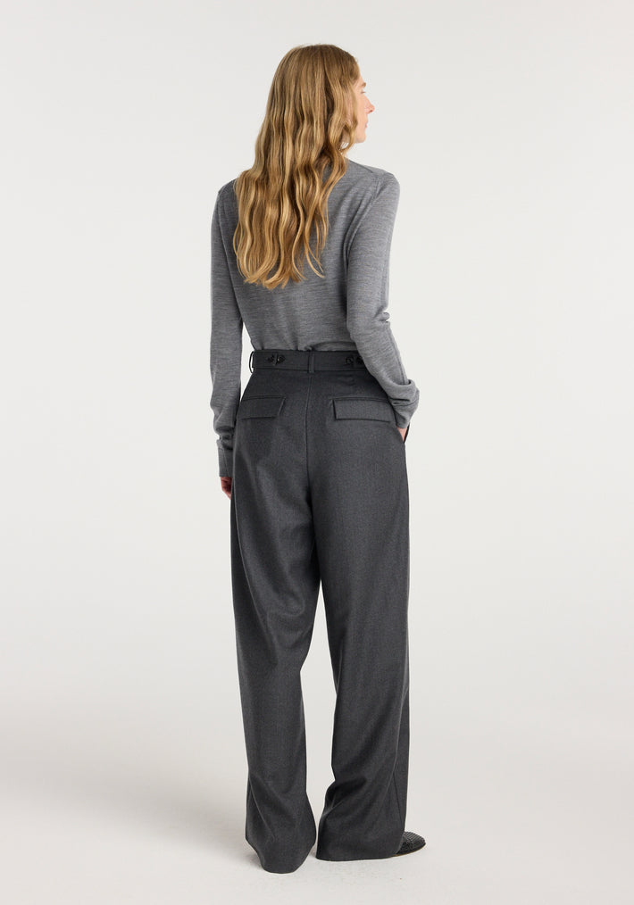 Woman wearing wide leg trousers | dark grey melange with a fitted long sleeve grey top, shown from the back against a plain background.