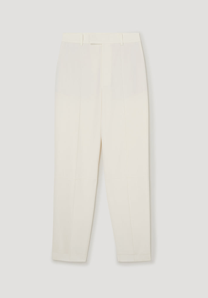 Daria - Single pleat tapered trousers | off white shown flat, featuring a high waist and clean, tailored lines with a minimalist design.