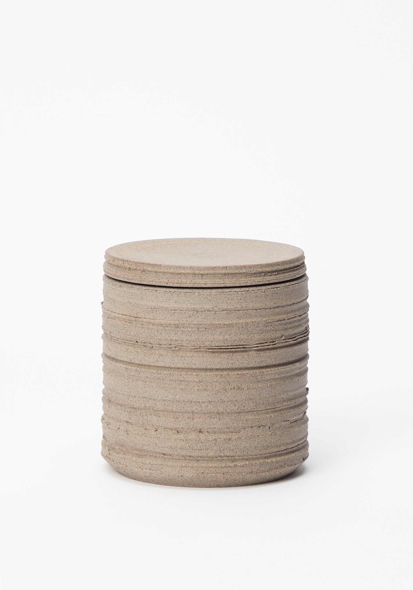 Diplomatico Scented Candle in stone: a handmade, earthy, layered ceramic vessel by Alex Gabriels, designed to hold Róhe's woody-aromatic scent.
