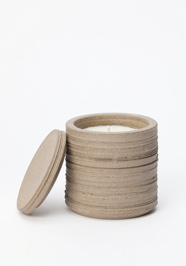 Diplomatico Scented Candle in a rough-textured ceramic vessel with a lid, showcasing off-white wax and centered wick, highlighting its repurposable design and unique fragrance blend.
