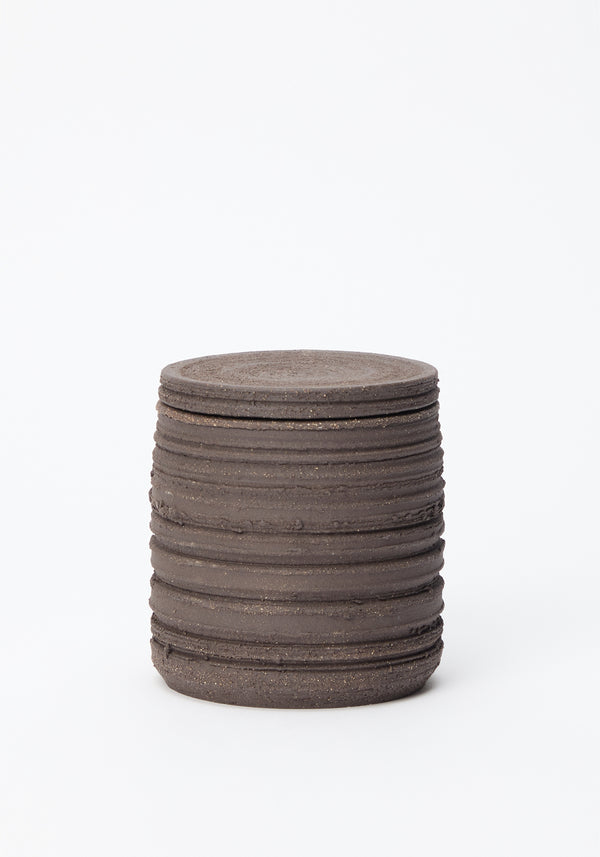 Diplomatico Scented Candle | soil in a handmade ceramic vessel with horizontal ridges, featuring a brutalist design, infused with a woody-aromatic fragrance.