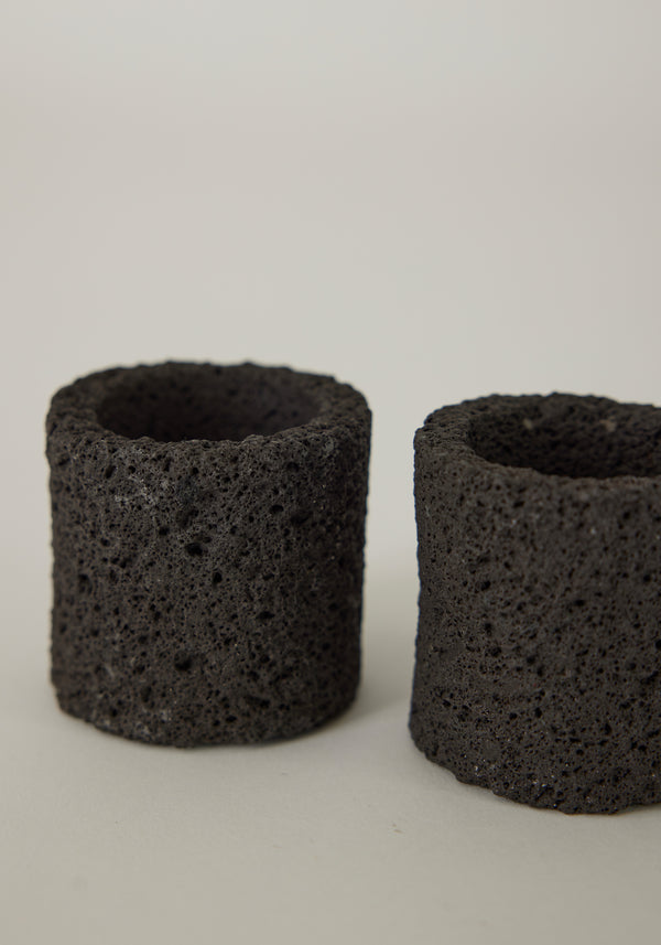 Egg Cups made of dark porous lava stone, handcrafted by Dutch artist Louis Crombag, showcasing unique textures. Set of two, each 6 cm tall.