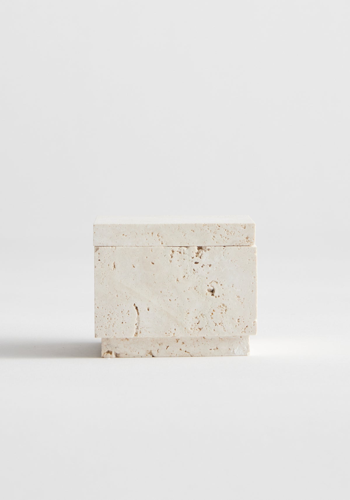 Tealight box | travertine: A small, handcrafted travertine box with lid, showcasing natural texture and pitting, designed for tealight or versatile use, on a white background.