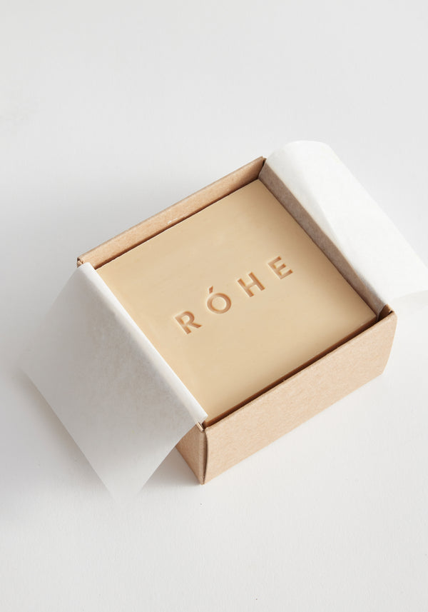 Diplomatico Soap | mist: A square, pale-beige soap partially wrapped in tissue, embossed with RÓHE, and nestled in an unbleached cardboard box.