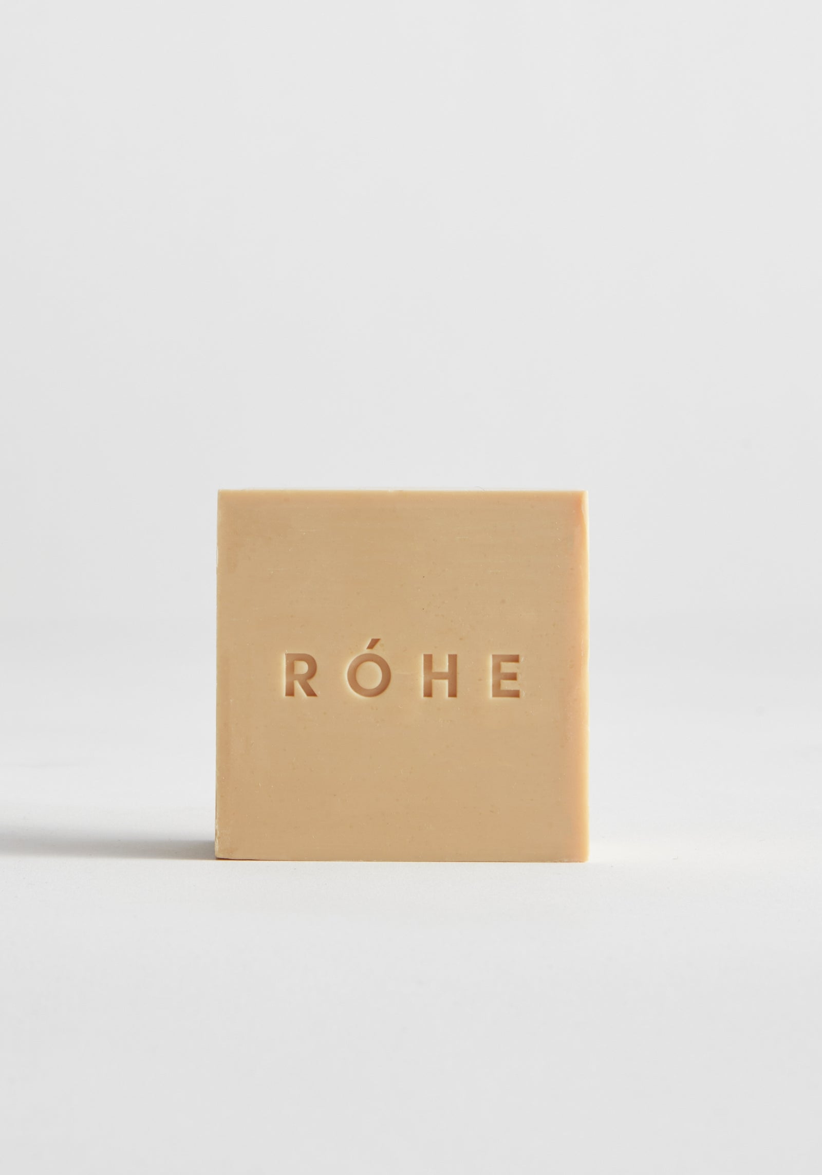 Diplomatico Soap | mist: Square beige soap with “RÓHE” embossed, offering a woody scent blend, enriched with eco-certified coconut oil for a creamy, nourishing lather.