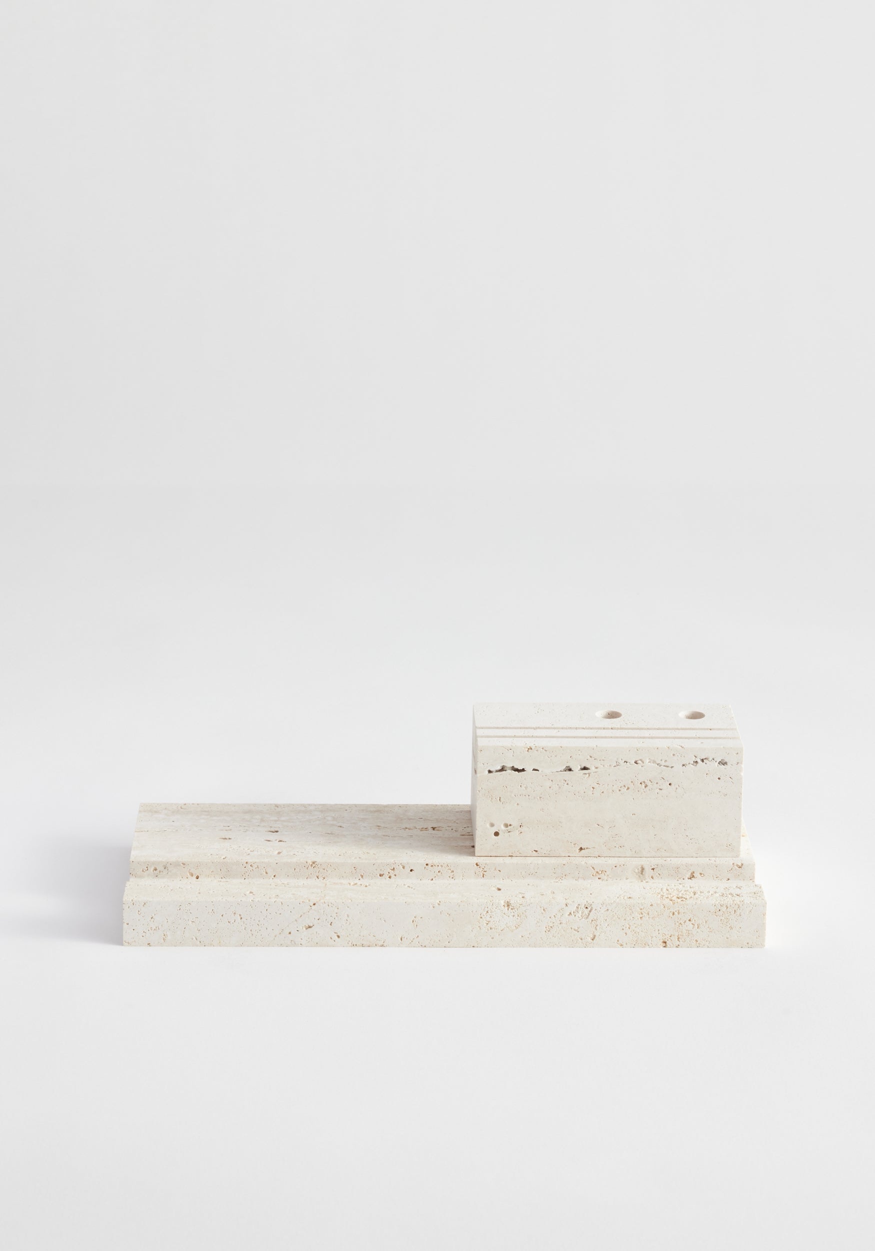 Desk organizer | travertine: Two-piece stone set with drilled holes and grooves, handcrafted from Italian travertine by Louis Crombag, ideal for organizing desk items.
