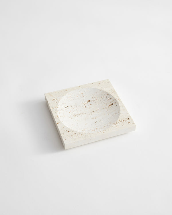 Small tray | travertine: A handcrafted, square travertine block with a round indent, designed by Louis Crombag, showcasing unique textures from natural stone variations.