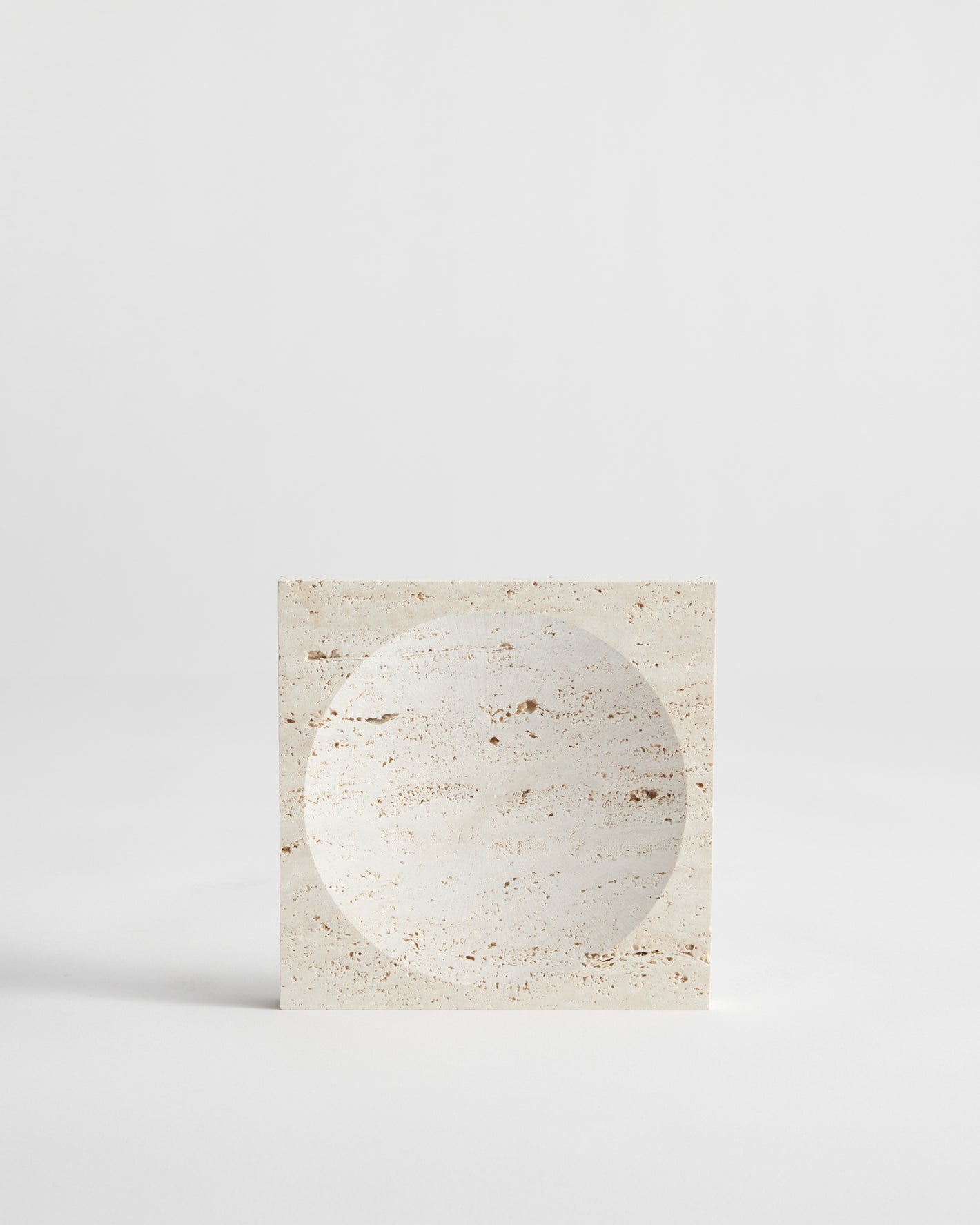 Small tray | travertine: A handcrafted square travertine tray with a circular indent, showcasing minimalist design. Created by Dutch artist Louis Crombag.