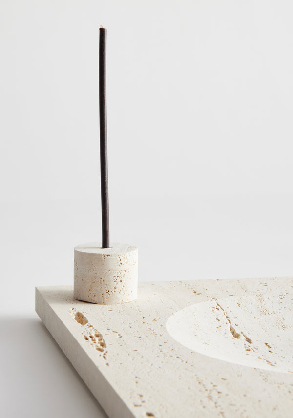 Large tray | travertine displayed with an unlit incense stick in a cylindrical holder, showcasing minimalist design on a travertine surface.