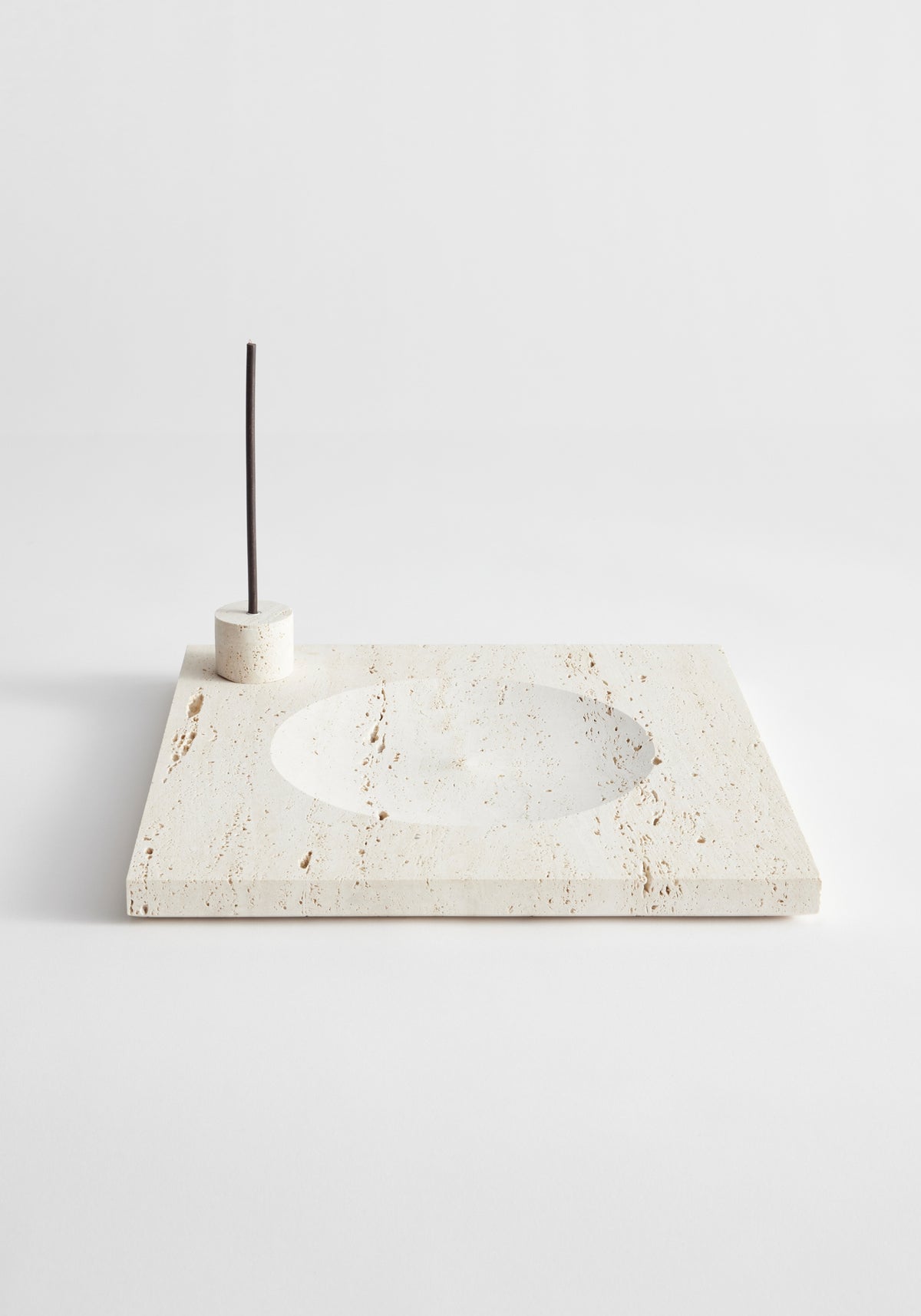 Large tray | travertine: Beige travertine slab with circular indent and incense holder, handcrafted in the Netherlands. Includes two 5mm candles.