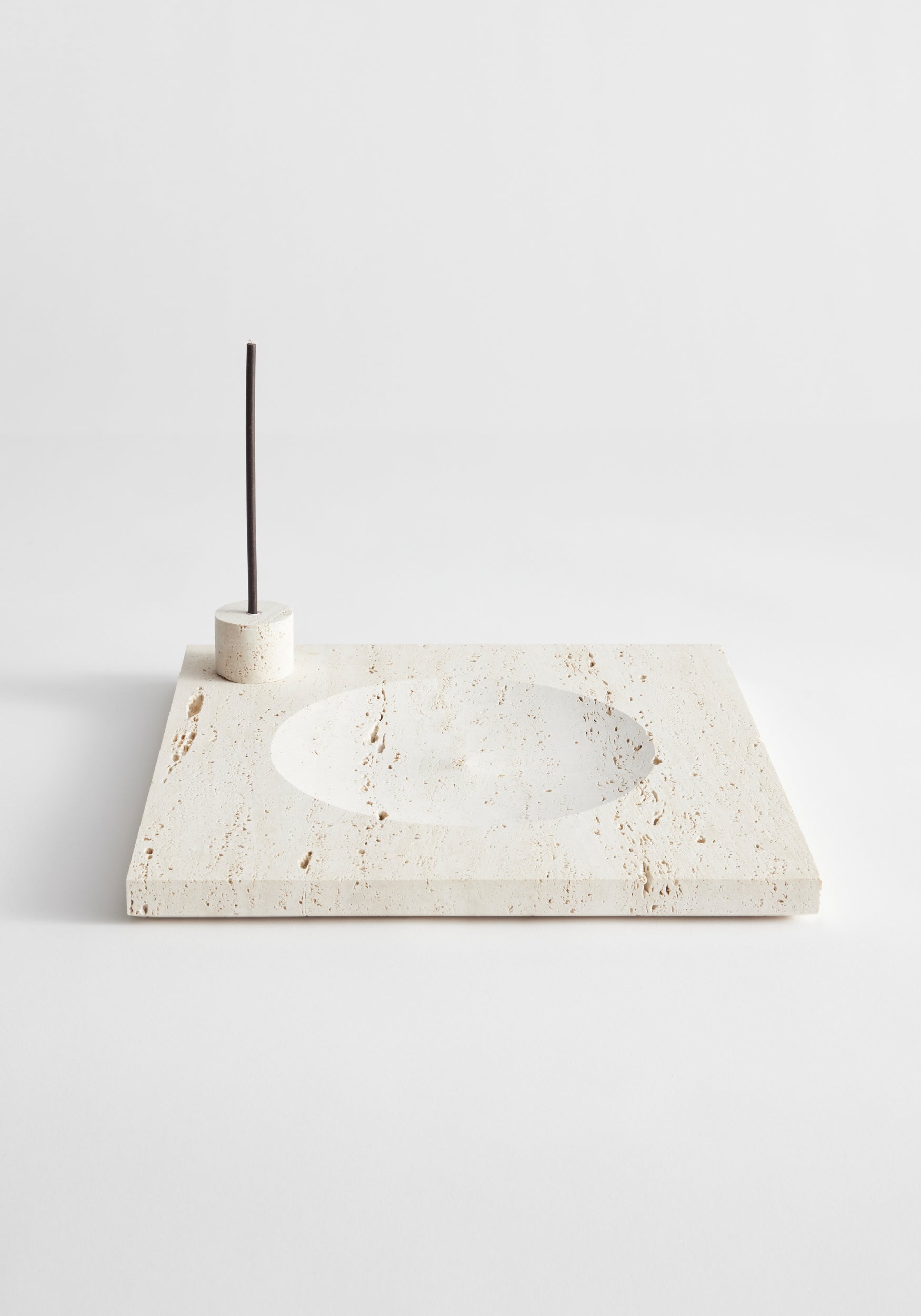 Large tray | travertine: Beige travertine slab with circular indent and incense holder, handcrafted in the Netherlands. Includes two 5mm candles.