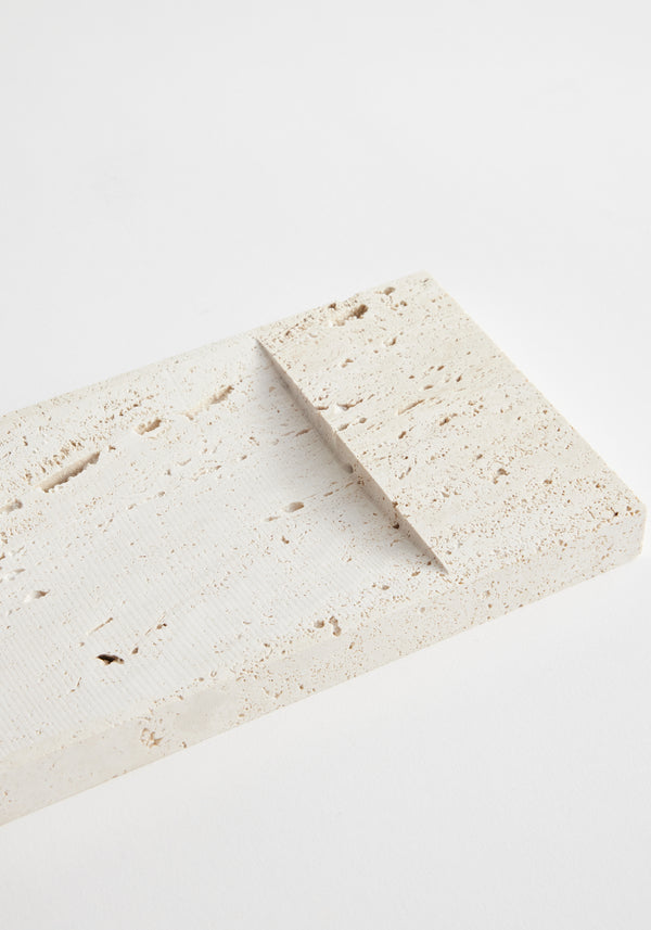 Incense holder tray | travertine: Two handcrafted beige travertine slabs, textured and rectangular, with one angled atop the other, showcasing unique, porous surfaces.