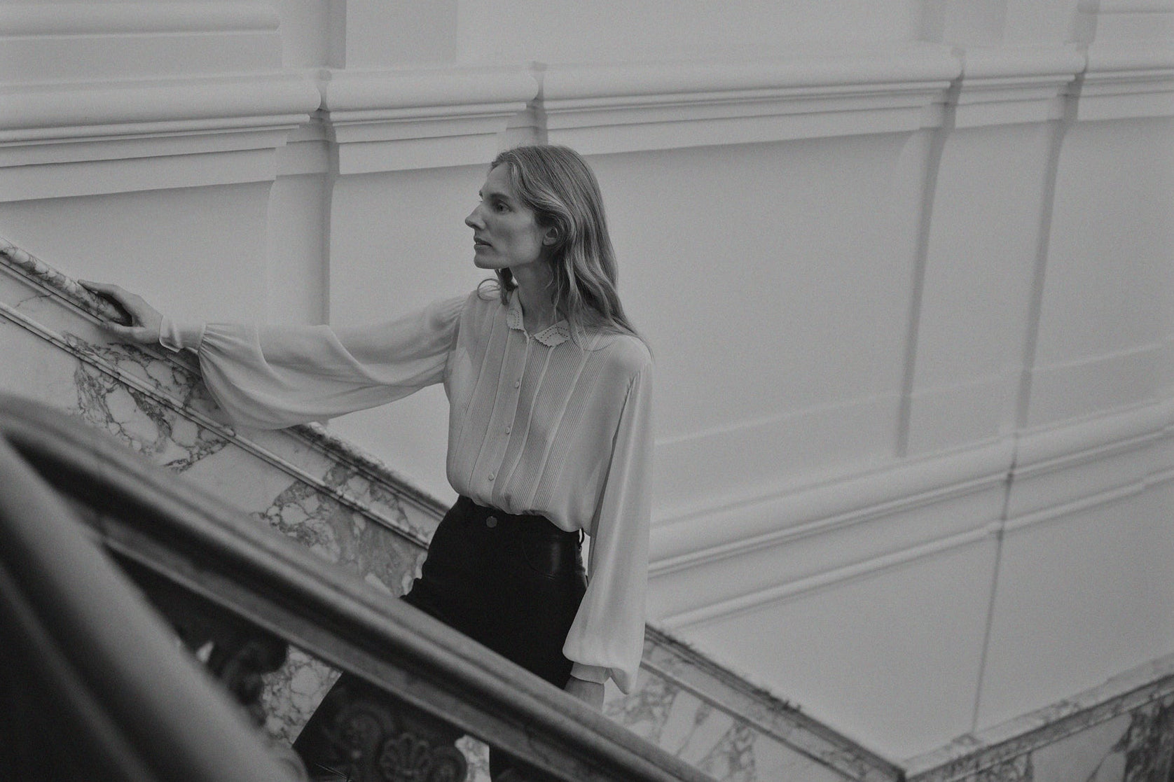 Woman in a silk blouse in an Amsterdam building