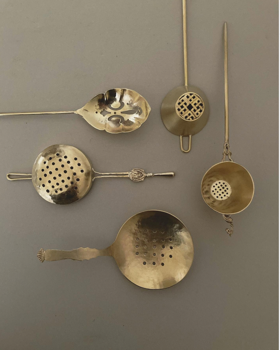 Tea Strainer: A collection of vintage-style, handcrafted brass strainers with intricate, lacy designs and decorative handles, inspired by traditional Japanese artistry.